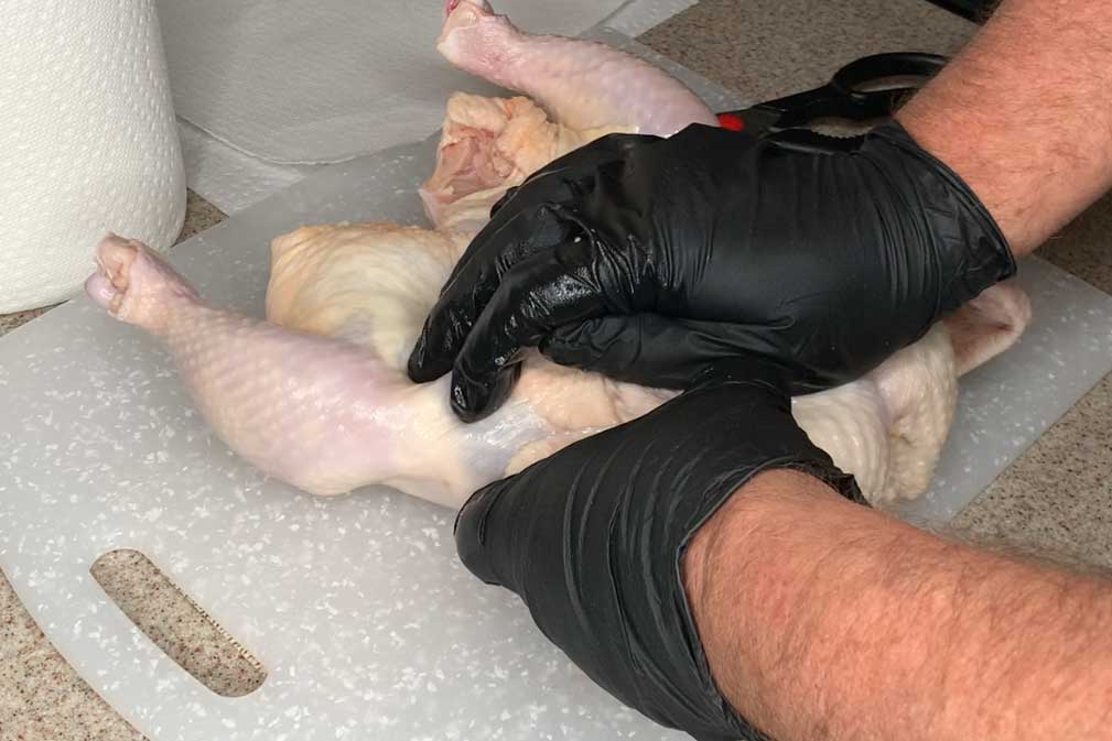 Cracking the breastbone of a chicken for a spatchcock chicken cook