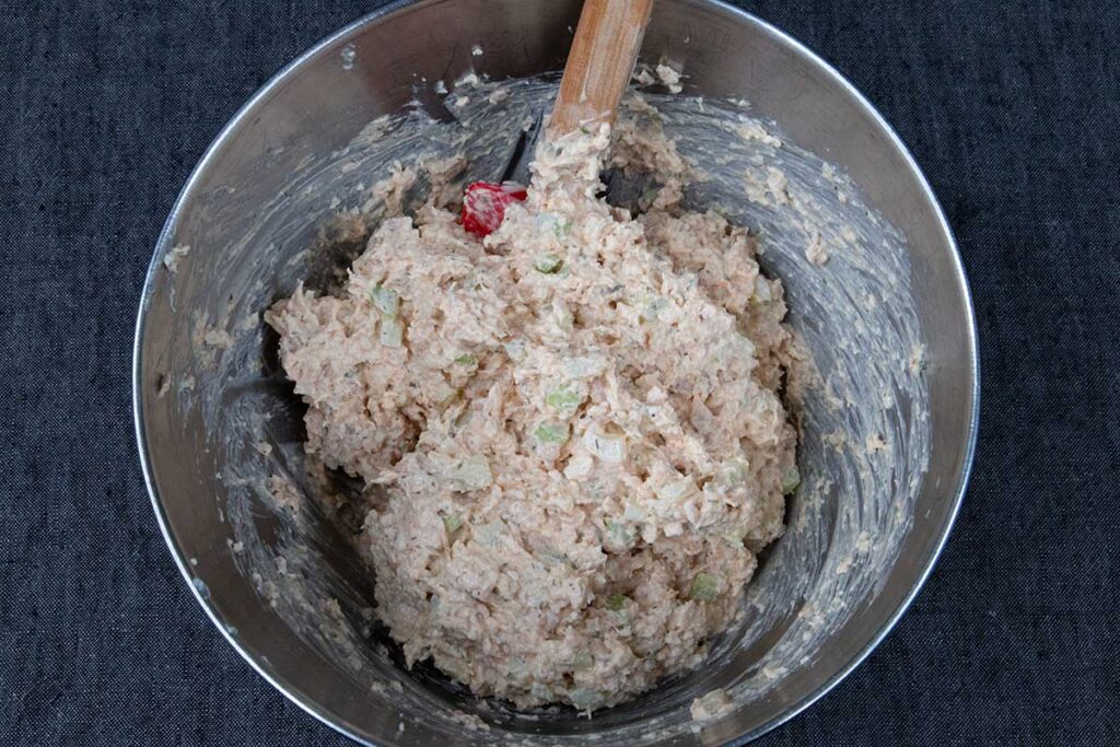 Smoked chicken salad combined in a metal bowl.