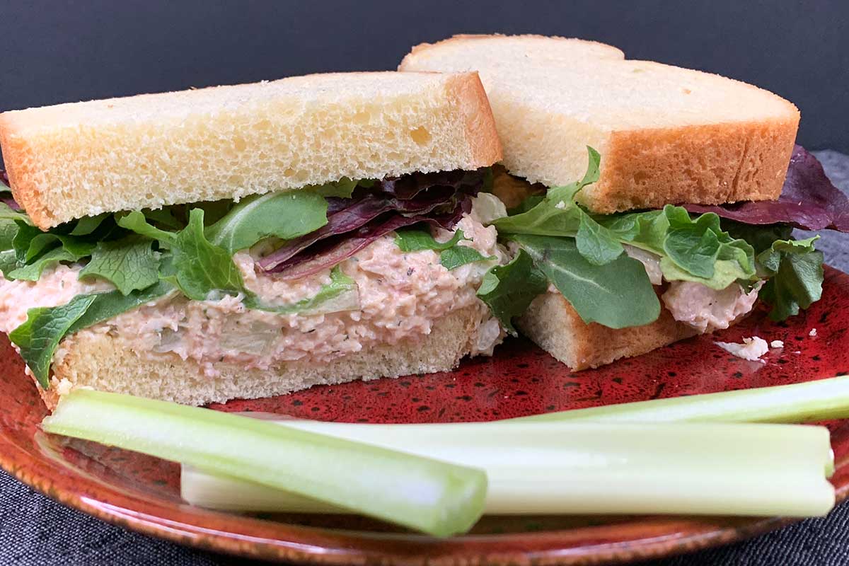smoked chicken salad sandwich on a red plate