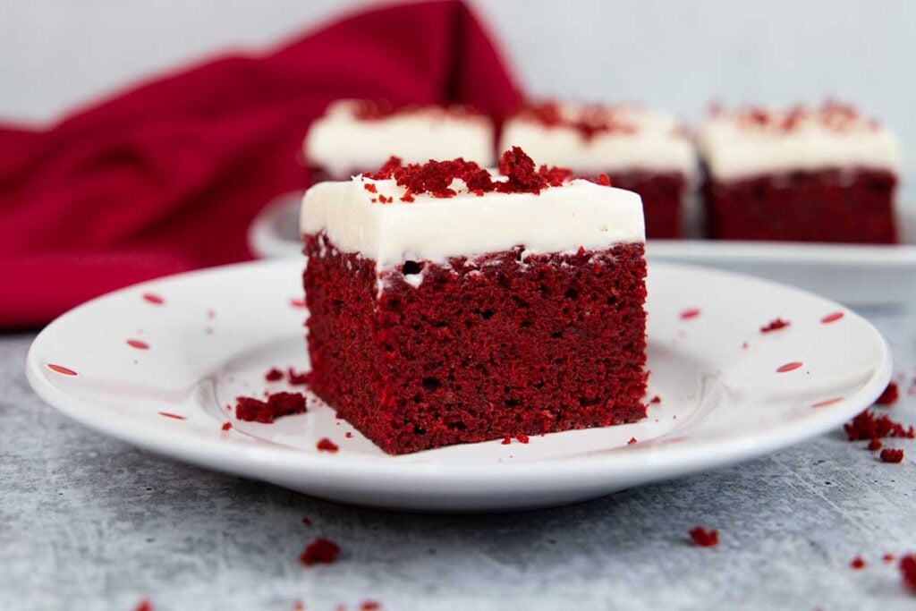 Red velvet brownie on a white plate with red dots.