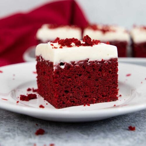 Red velvet brownie on a white plate with red dots.