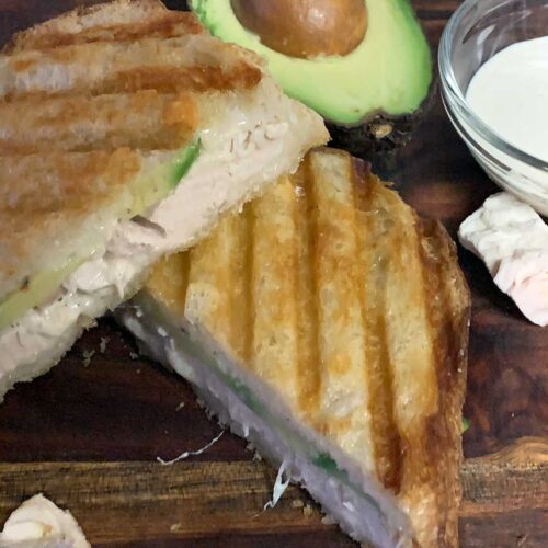 Smoked chicken panini on a cutting board