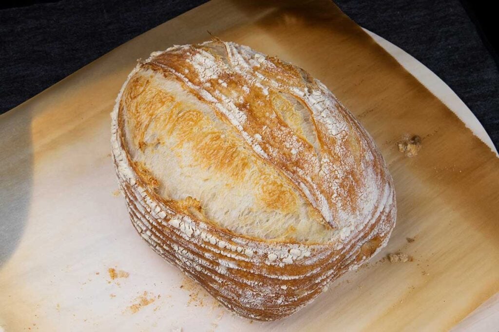 A batard of sourdough on a cutting board.