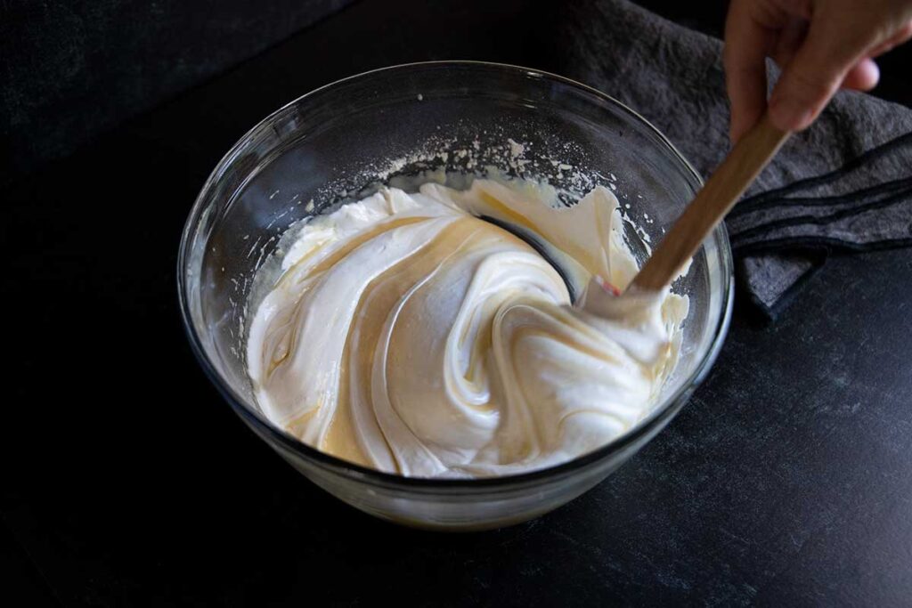 Coconut cake batter in a glass bowl.