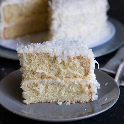 slice of coconut cake on a gray plate