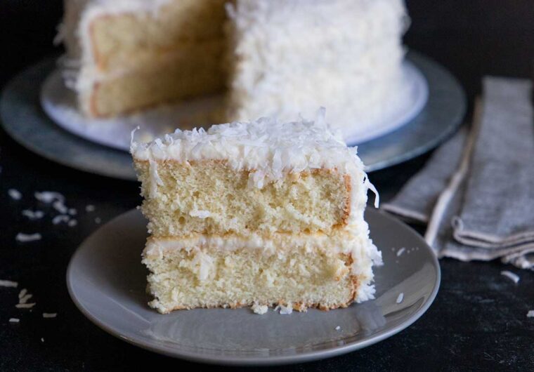 slice of coconut cake on a gray plate