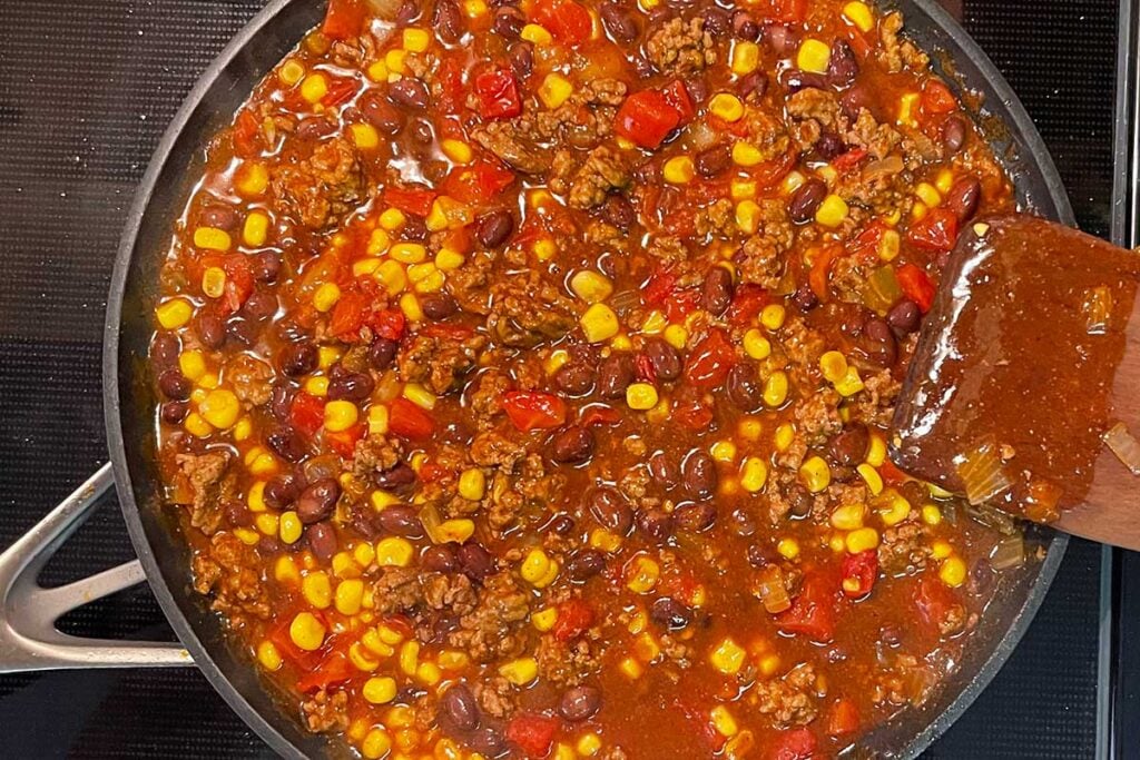 Frito pie mixture cooking on stovetop