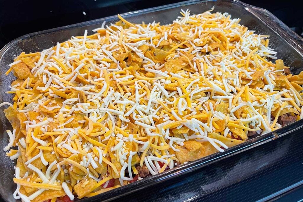 Frito pie casserole assembled and ready for baking