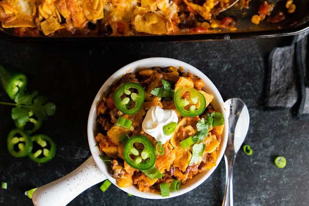 Frito pie casserole in a white bowl