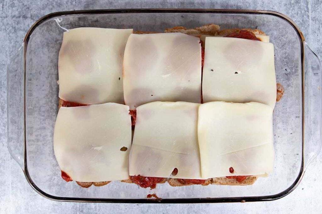 Cheese slices on top of the meatballs.