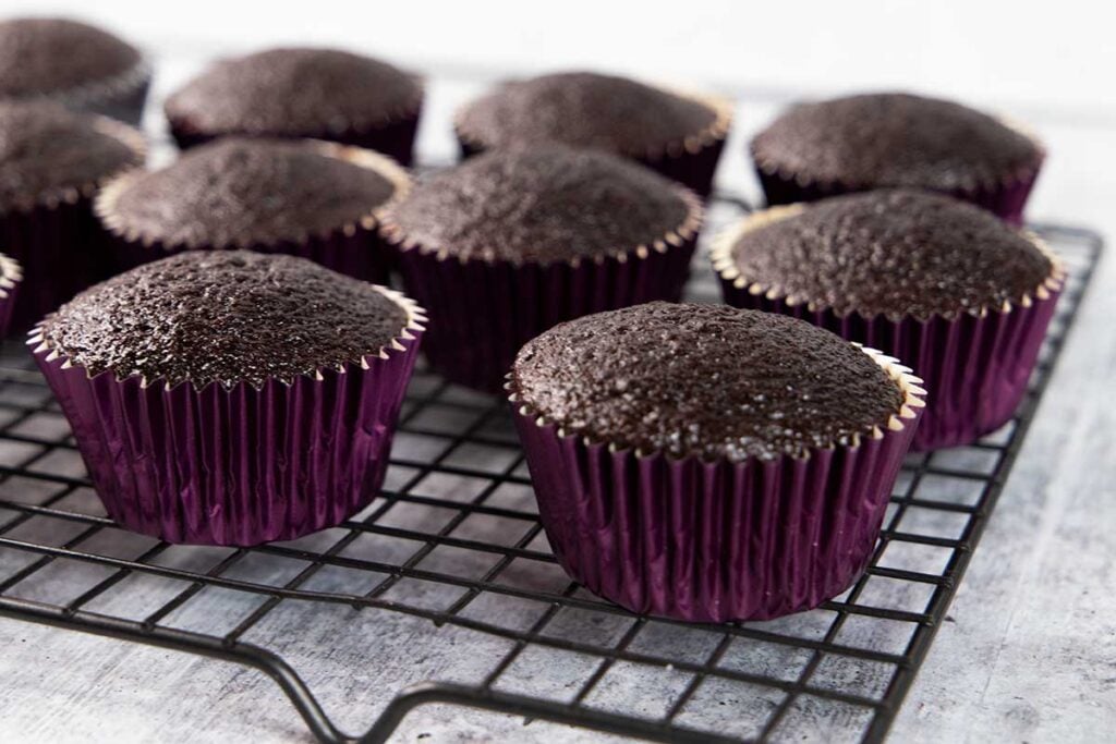 unfrosted chocolate cupcakes on a wire rack