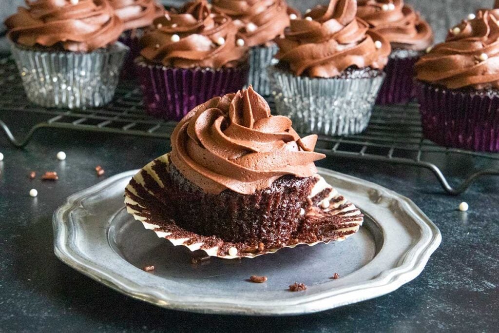 A chocolate cupcake on a pewter platter