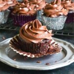 A chocolate cupcake on a pewter platter