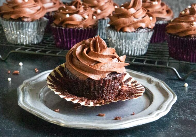 A chocolate cupcake on a pewter platter