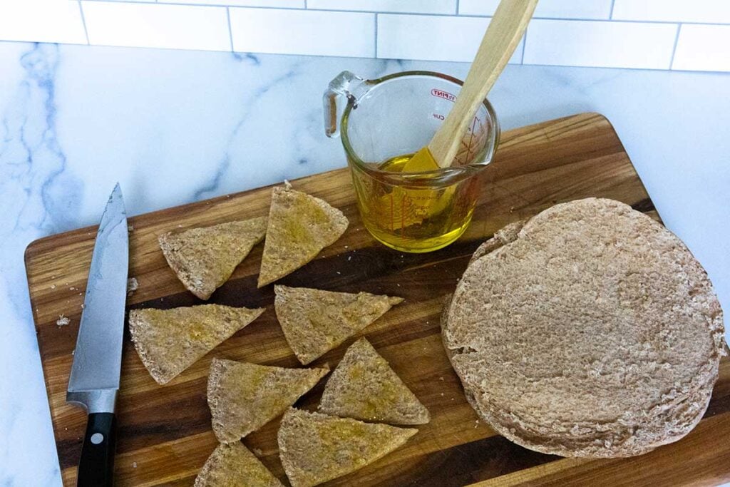 Brushing pita bread with olive oil