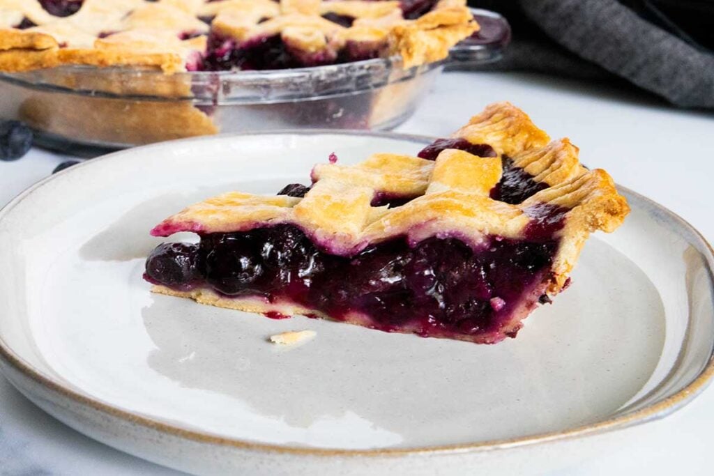 slice of blueberry pie on a white plate