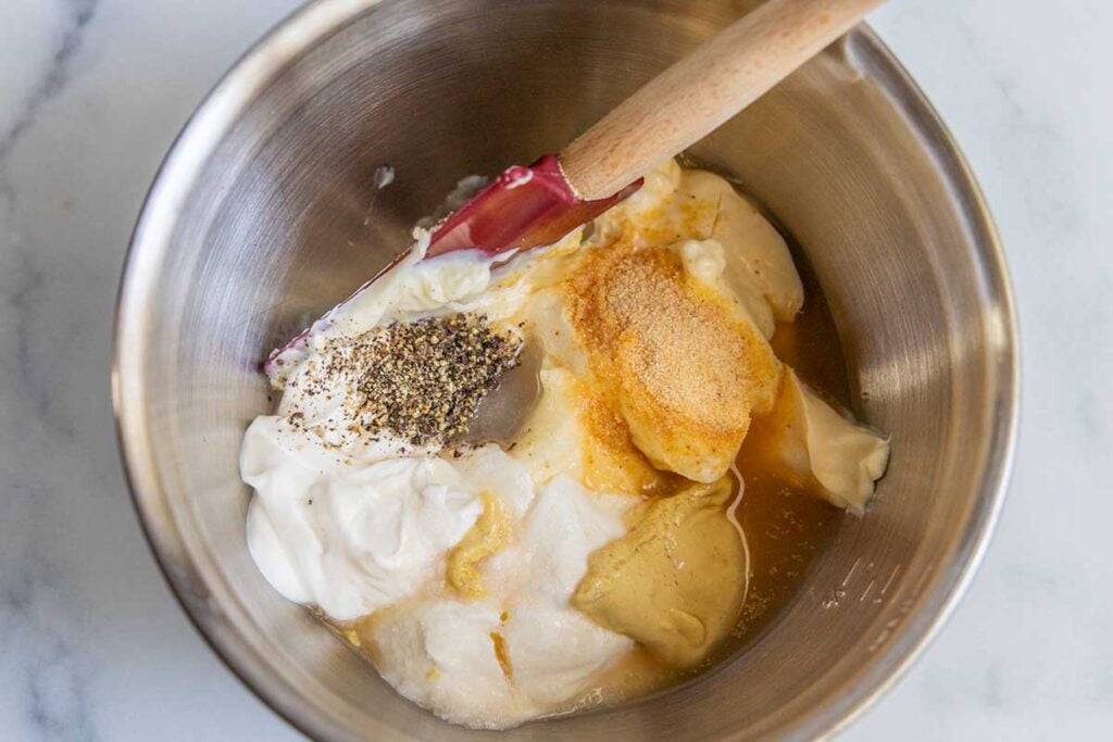 macaroni salad dressing ingredients in a metal bowl