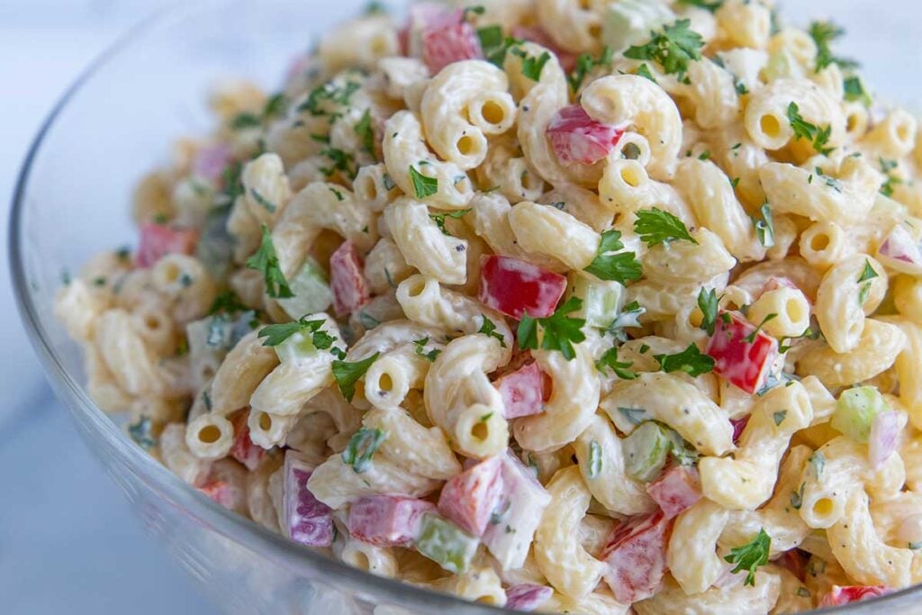 Macaroni salad in a glass bowl.