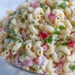 Macaroni salad in a glass bowl.