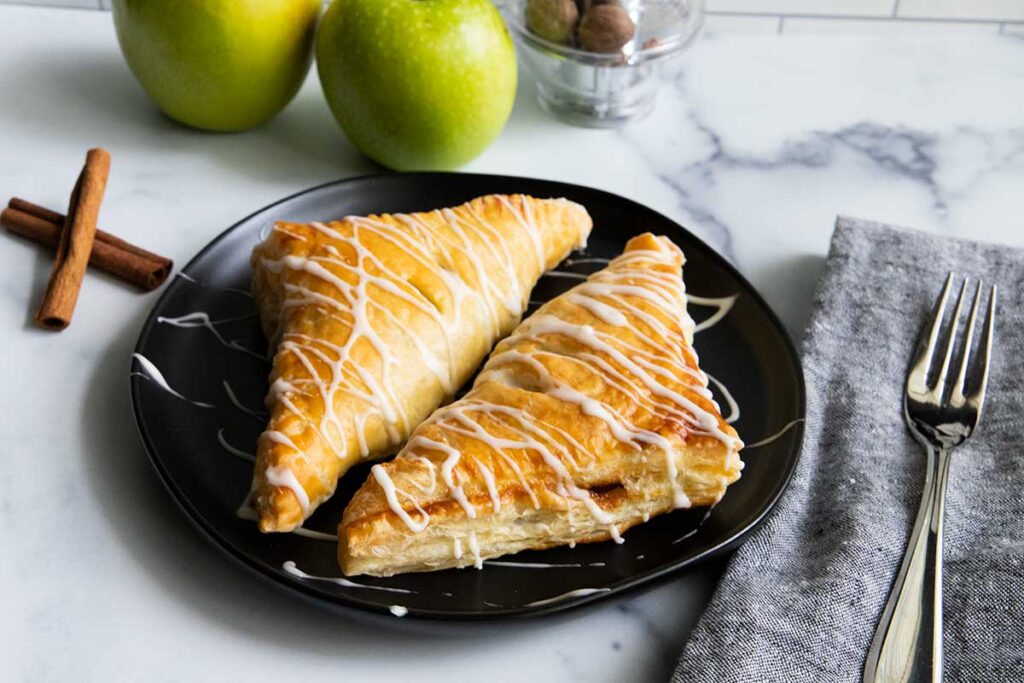 apple turnovers on a black plate
