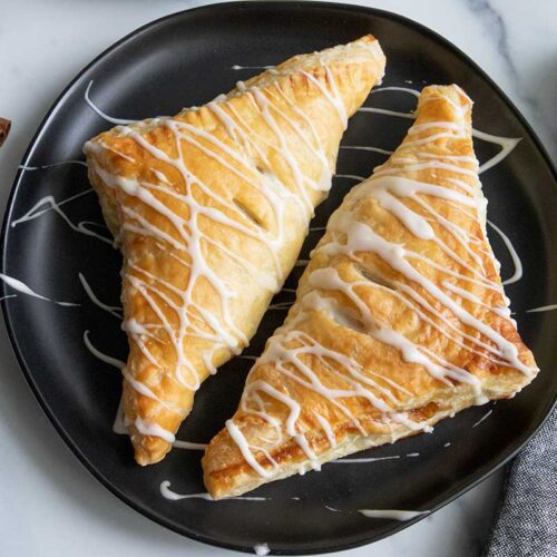 apple turnovers on a black plate