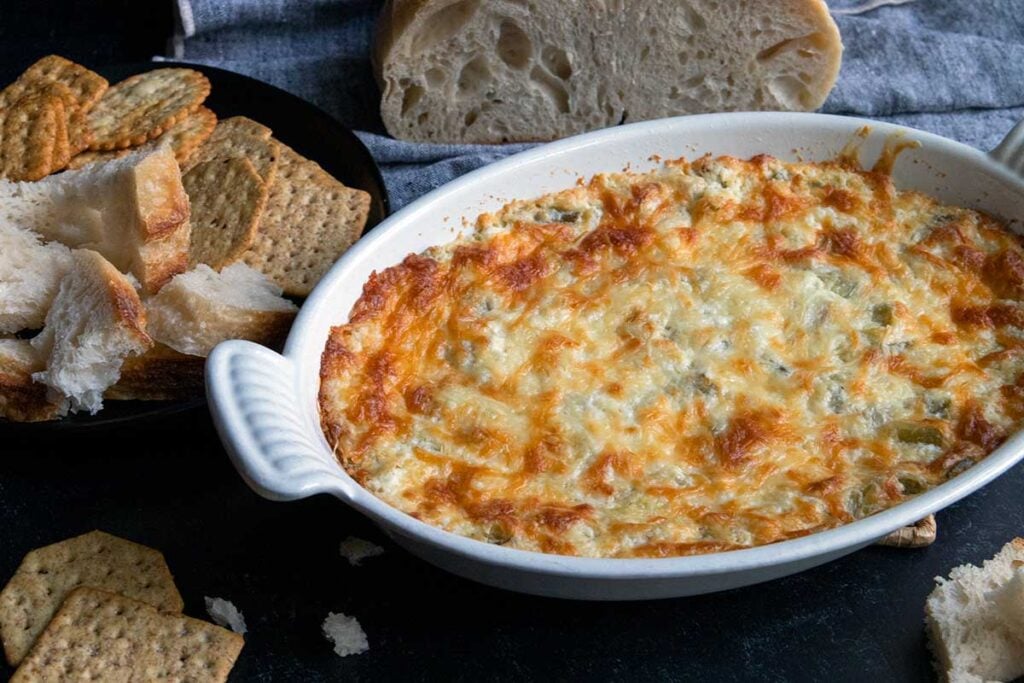 artichoke dip in a white baking pan