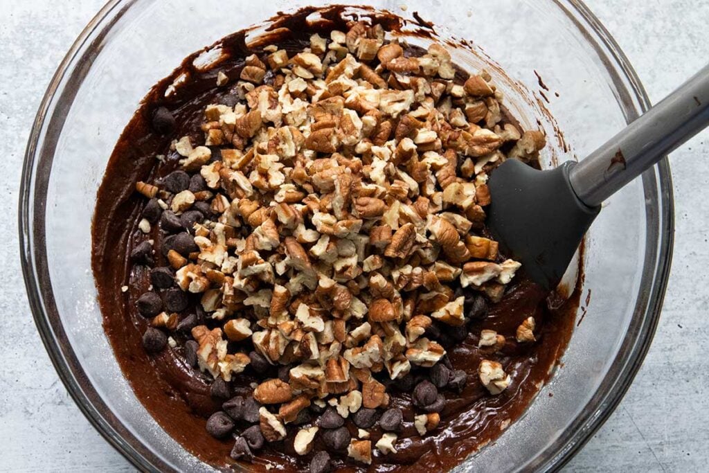 Brownie cookie batter in a glass mixing bowl.