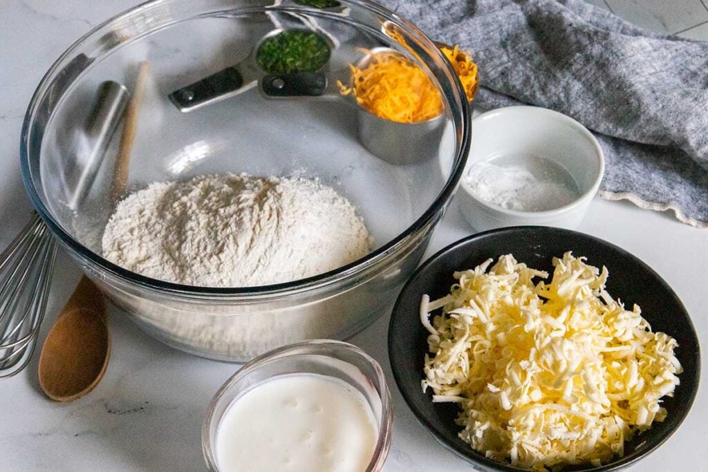 Flour, buttermilk, grated butter, chopped chives, and finely shredded cheese.