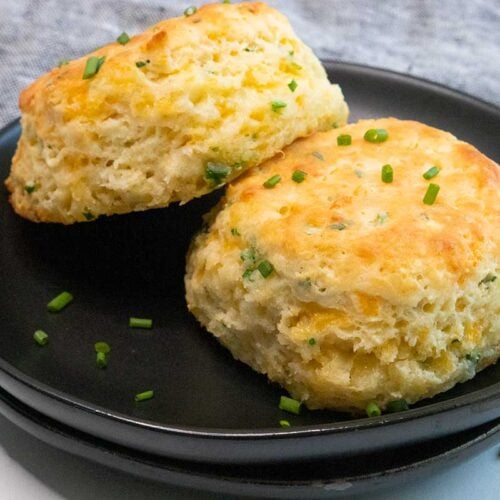 cheddar chive biscuits on a black plate