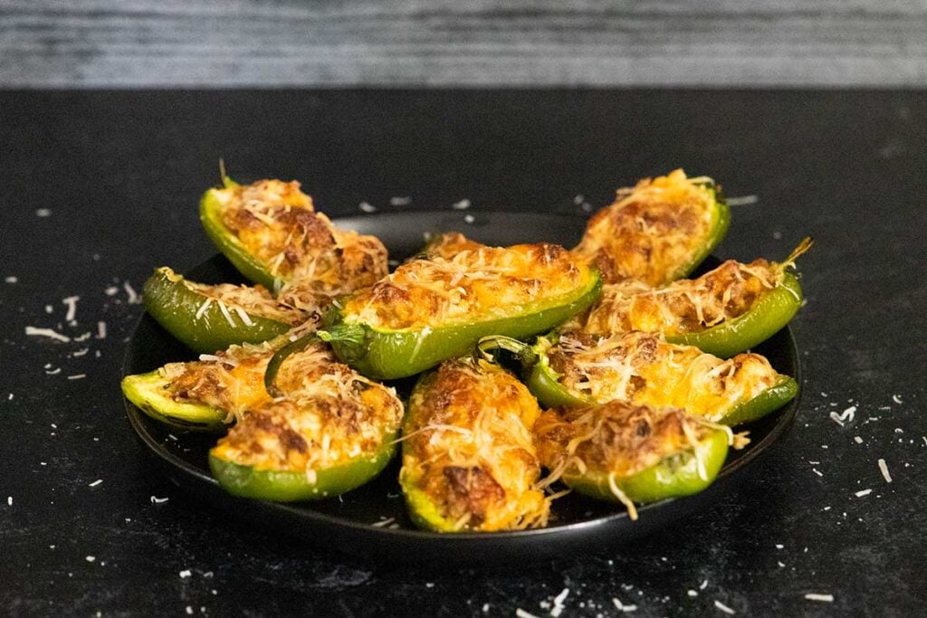 jalapeno poppers on a black plate