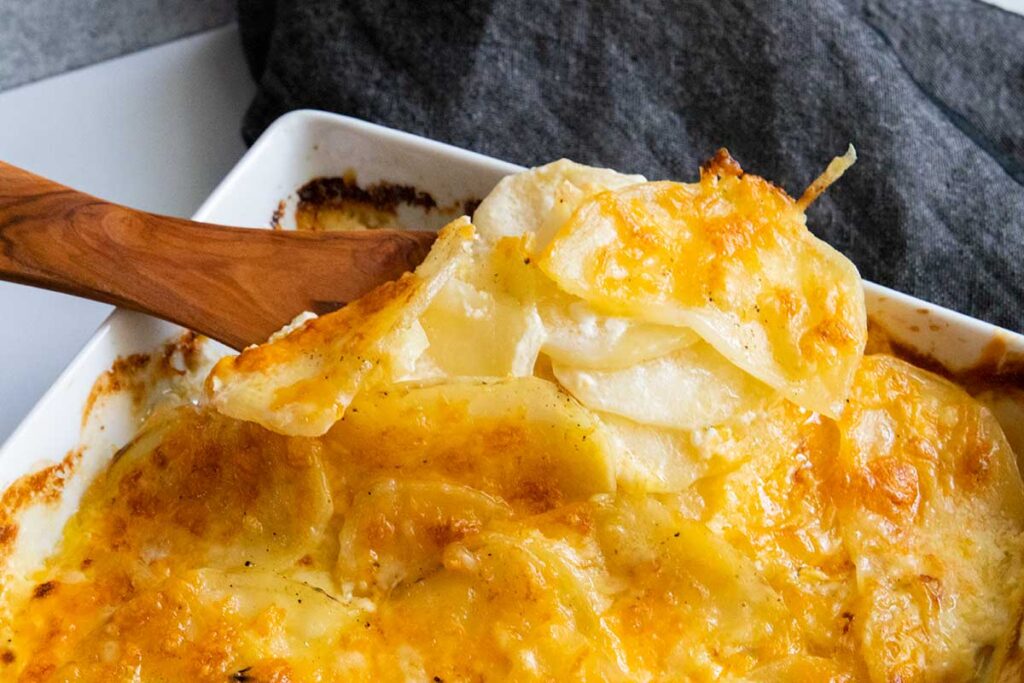 Potatoes au gratin spooned out of the baking dish.