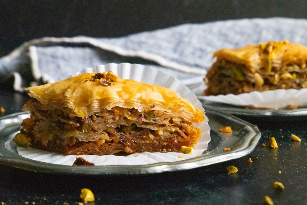 Baklava slices on sliver plates.