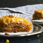 Baklava slices on sliver plates.