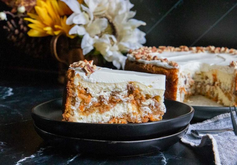 slice of carrot cake cheesecake on black plate