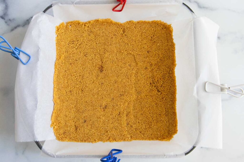 Graham cracker crust in a baking dish.