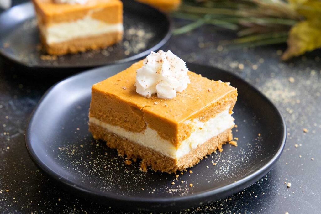 pumpkin cheesecake bar on a black plate