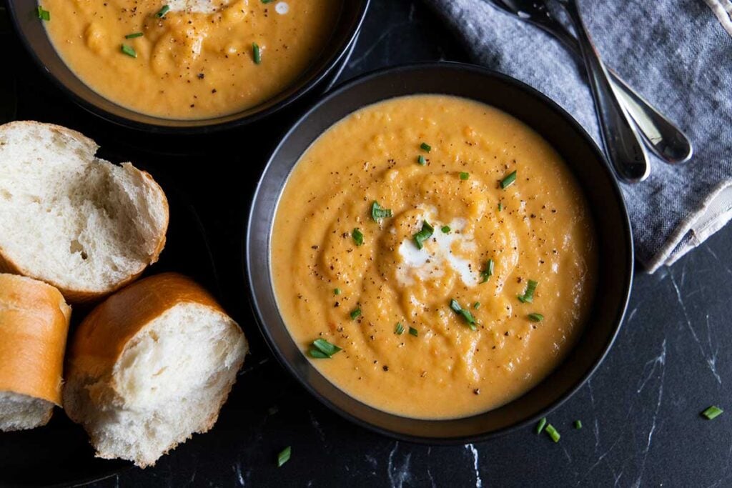 Root vegetable soup in black bowls.