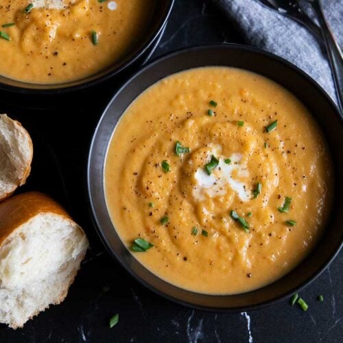 Root vegetable soup in black bowls.