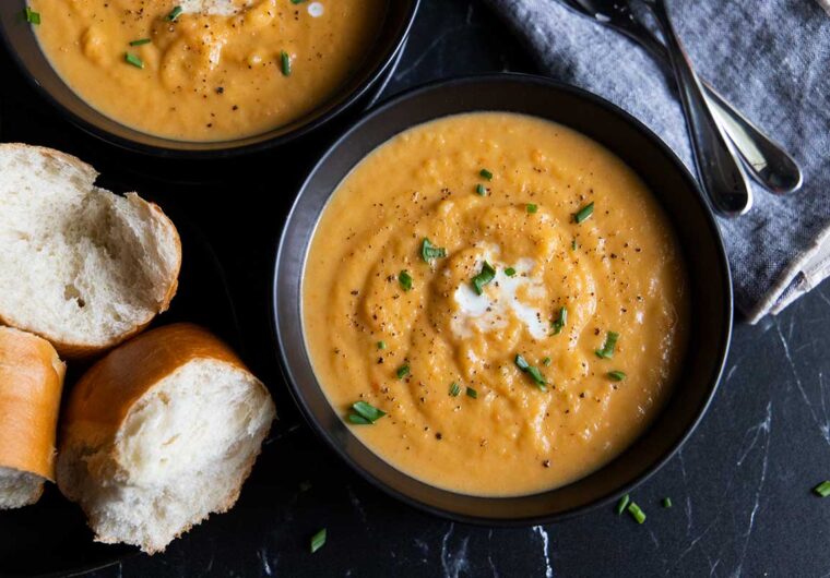 root vegetable soup in black bowls
