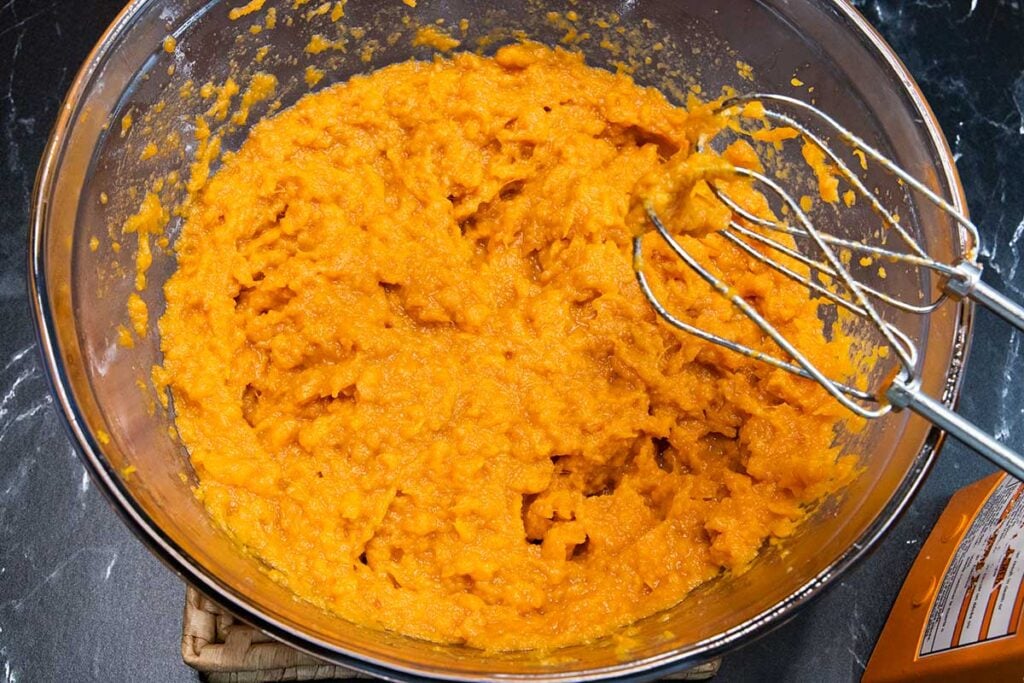 mashed sweet potatoes in a glass mixing bowl