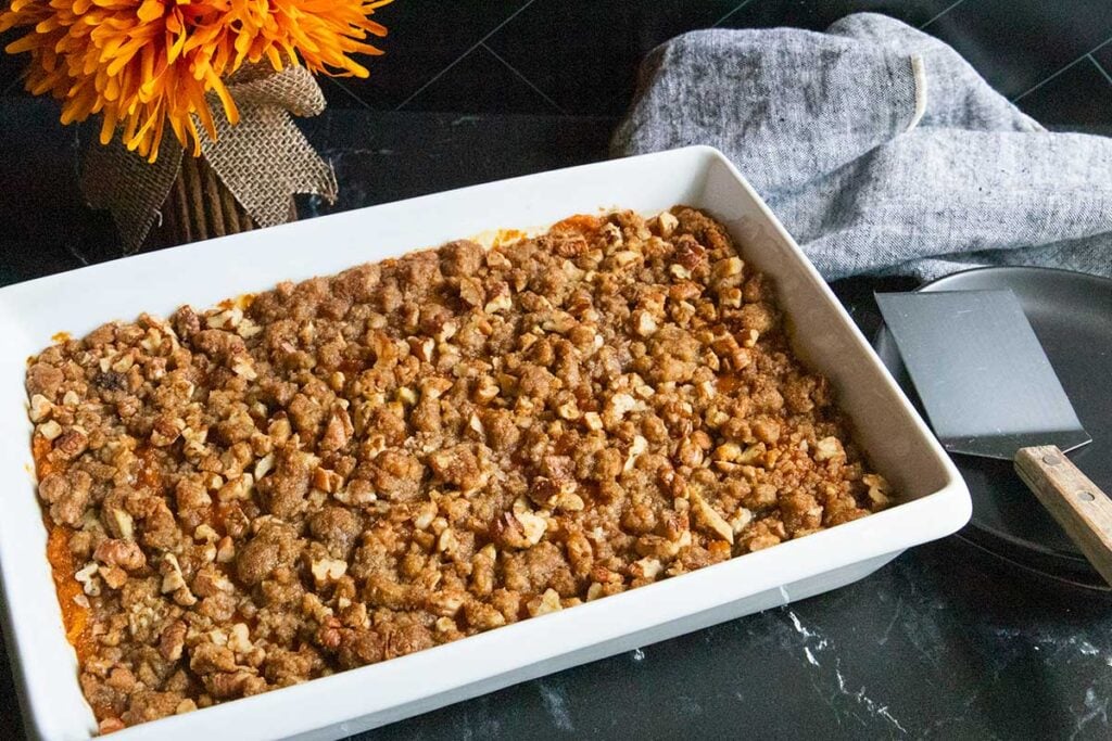sweet potato casserole in a white baking pan