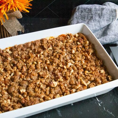 sweet potato casserole in a white baking pan