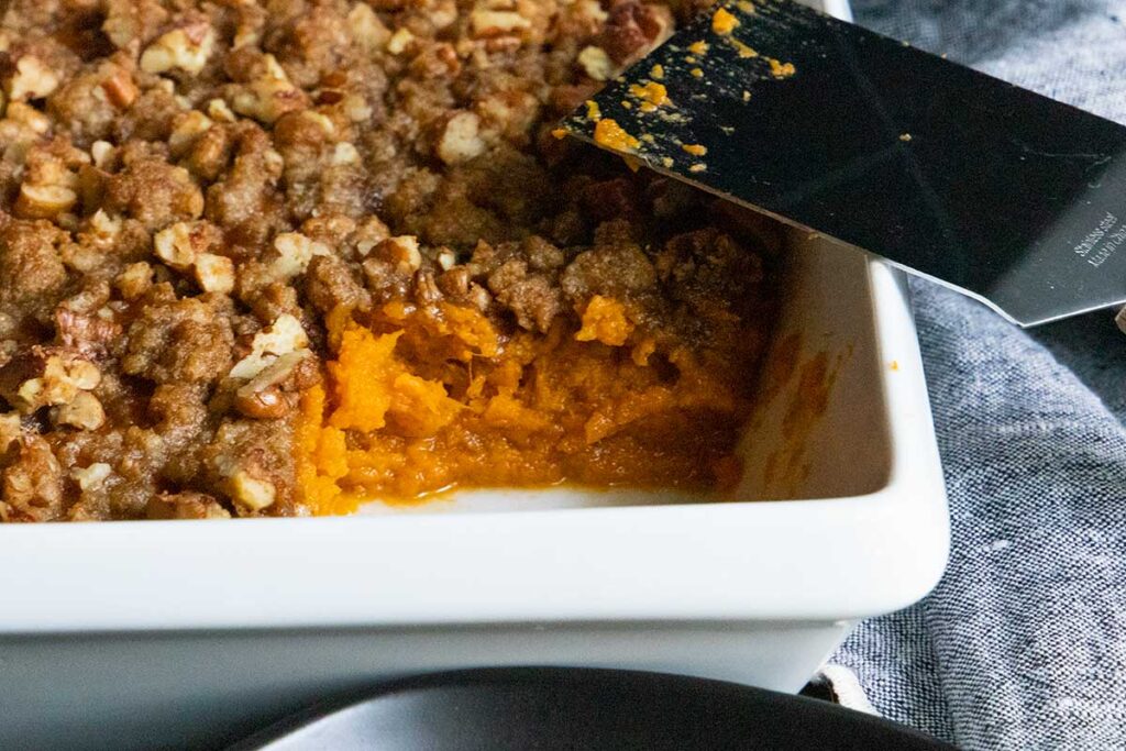 Sweet potato casserole in white pan.