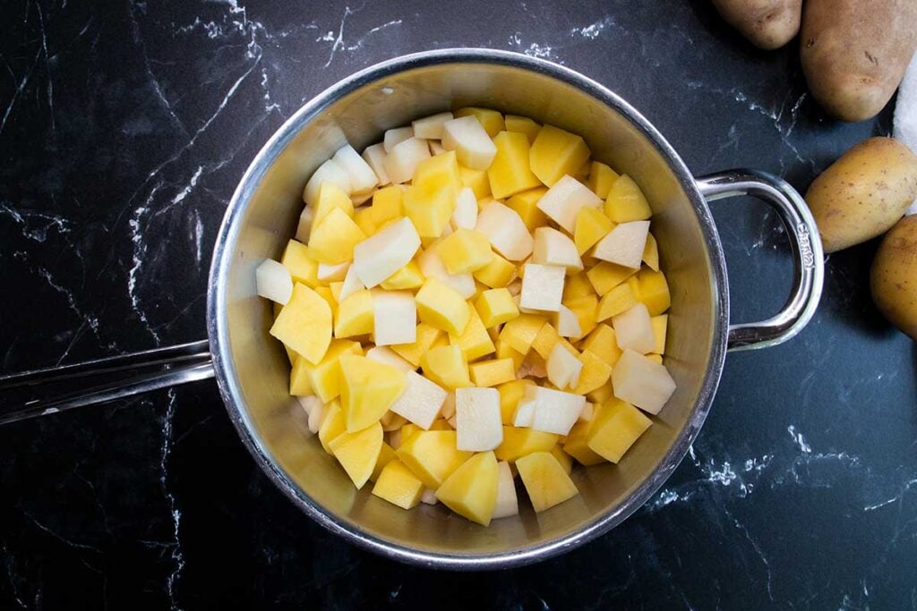 Potatoes cubed in a pot.