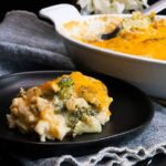 Broccoli rice casserole on black plate.