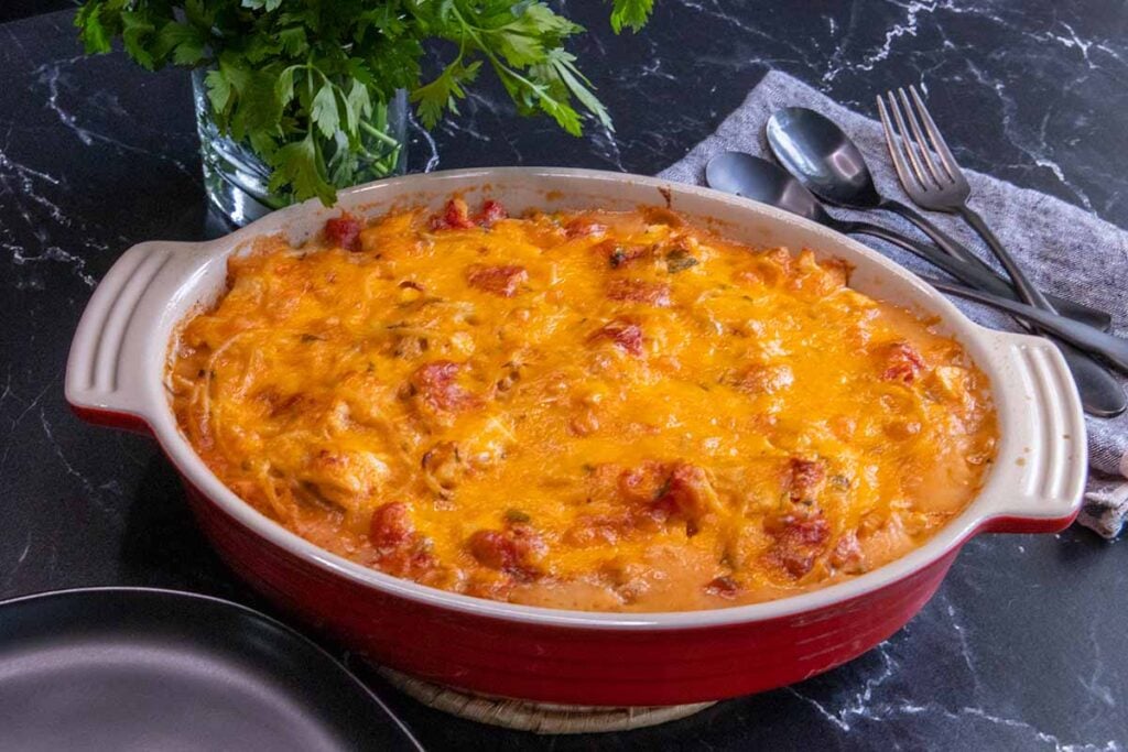 Chicken spaghetti in a red casserole.