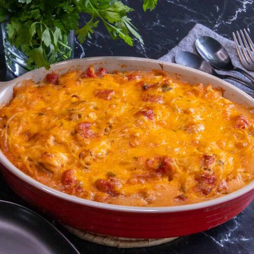 Chicken spaghetti in a red casserole.