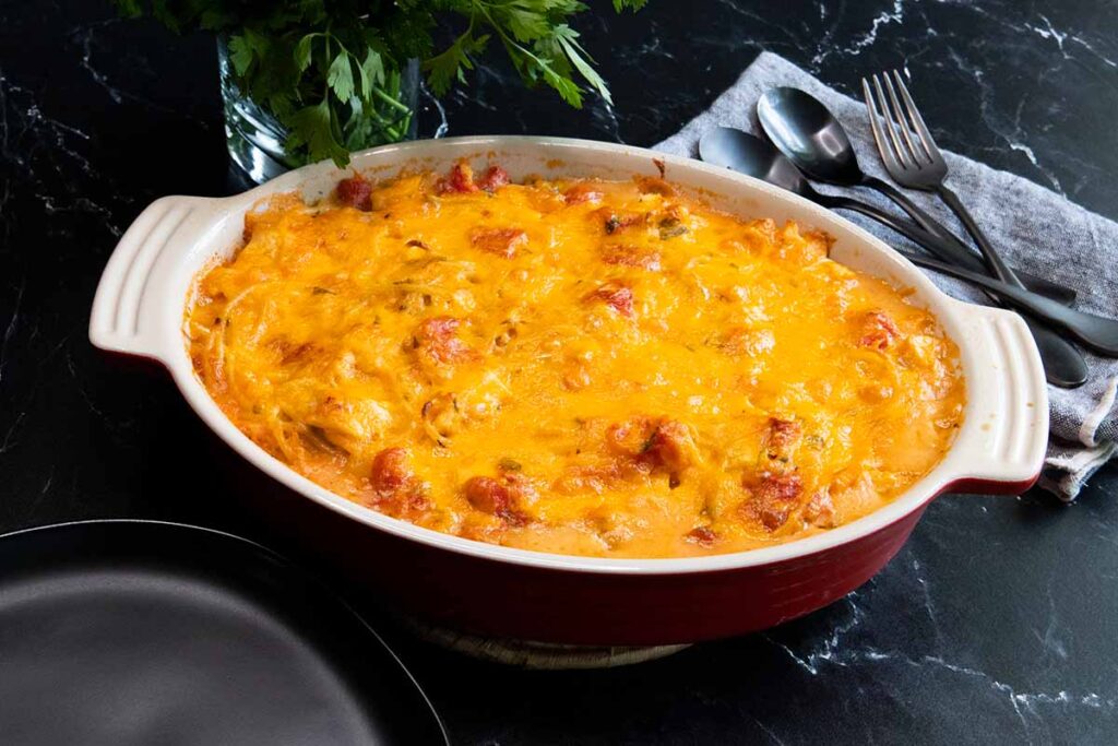 chicken spaghetti in a red casserole dish