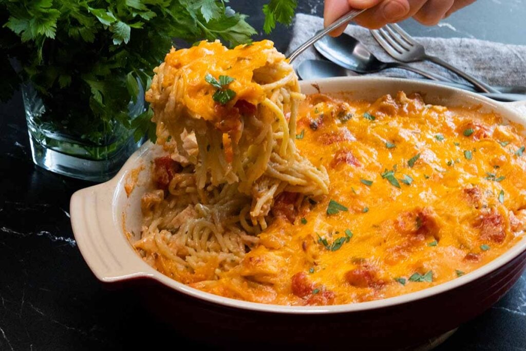 chicken spaghetti scooped out on a serving spoon