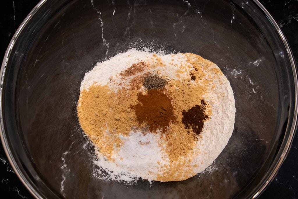 Spices and flour in a glass mixing bowl.
